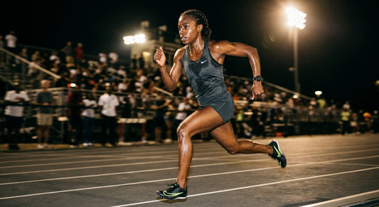 Professional high-speed athletic action photography of a runner dripping with sweat in the heat, moody dramatic contrast, sharp fine details, running motion blur, cinematic stadium lighting.