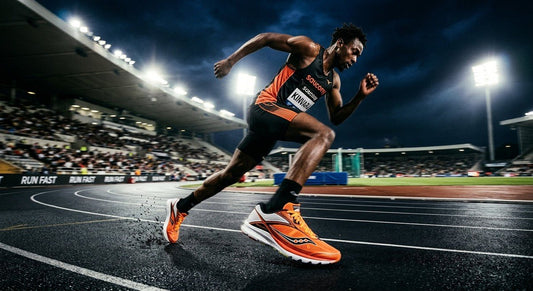 A professional action shot of the Saucony Kinvara 17 in a high-contrast stadium setting with dramatic lighting and motion blur.