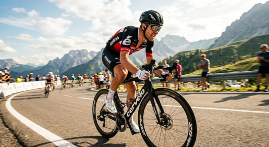 A professional cyclist wearing Bollé Shifter sunglasses during a high-speed sprint on a sun-drenched road.