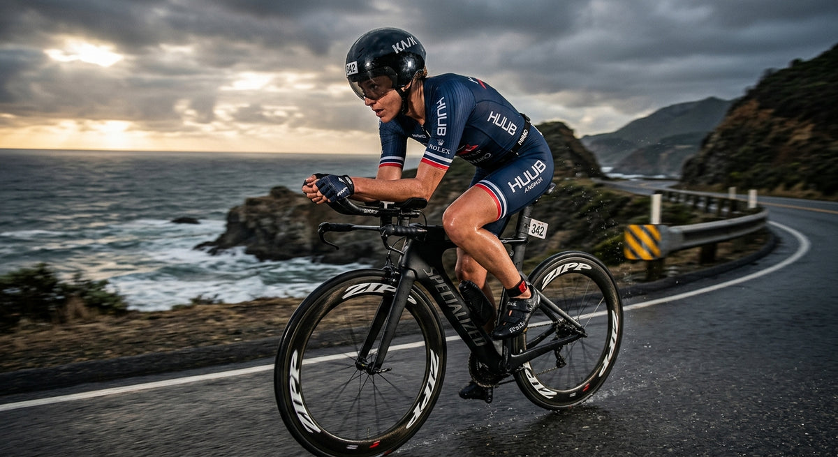 A professional triathlete in a sleek aero trisuit cycling at high speed on a coastal road with dramatic stadium-like cinematic lighting.