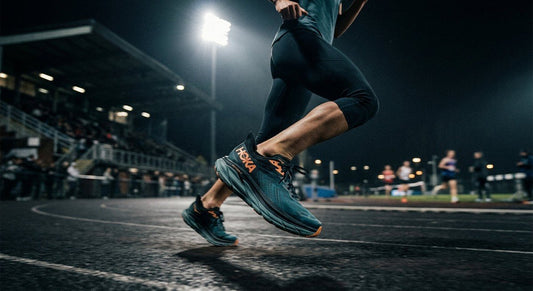 A side profile of the Hoka Skyflow 2 in a dark, moody stadium environment with dramatic lighting and motion blur