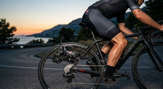 A close-up of a high-end Campagnolo Record 13 wireless rear derailleur on a carbon fibre frame with cinematic lighting.