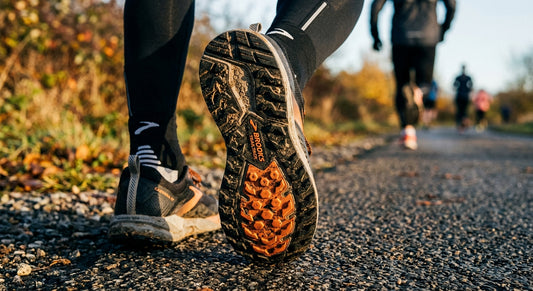 A close-up of a Brooks running shoe sole showing intricate lug patterns and high-performance rubber textures.