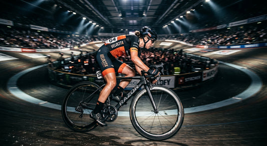 Professional cyclist in a high-speed motion blur, captured with dramatic cinematic stadium lighting and high-contrast textures.