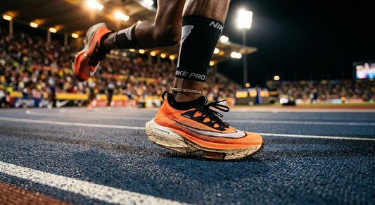 A close-up, high-speed action shot of a professional runner's foot striking the ground, highlighting the detailed texture of the midsole foam with cinematic stadium lighting.