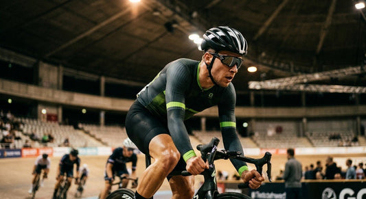 A professional athlete wearing sleek, aerodynamic sports sunglasses during a high-speed cycling sprint in cinematic stadium lighting.