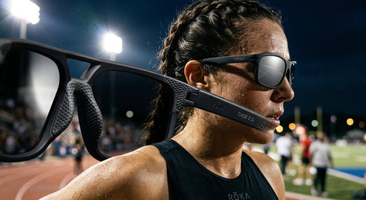 A close-up of a high-performance ROKA Cade 2.0 sunglasses frame showing the intricate GEKO grip texture under dramatic stadium lighting.