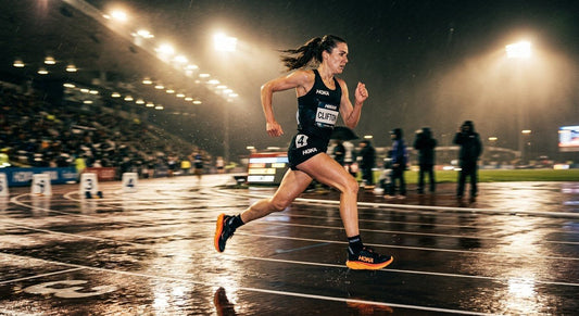 Professional high-speed action shot of a runner wearing HOKA Clifton 11s, featuring intense stadium lighting and motion blur on a rain-slicked track.