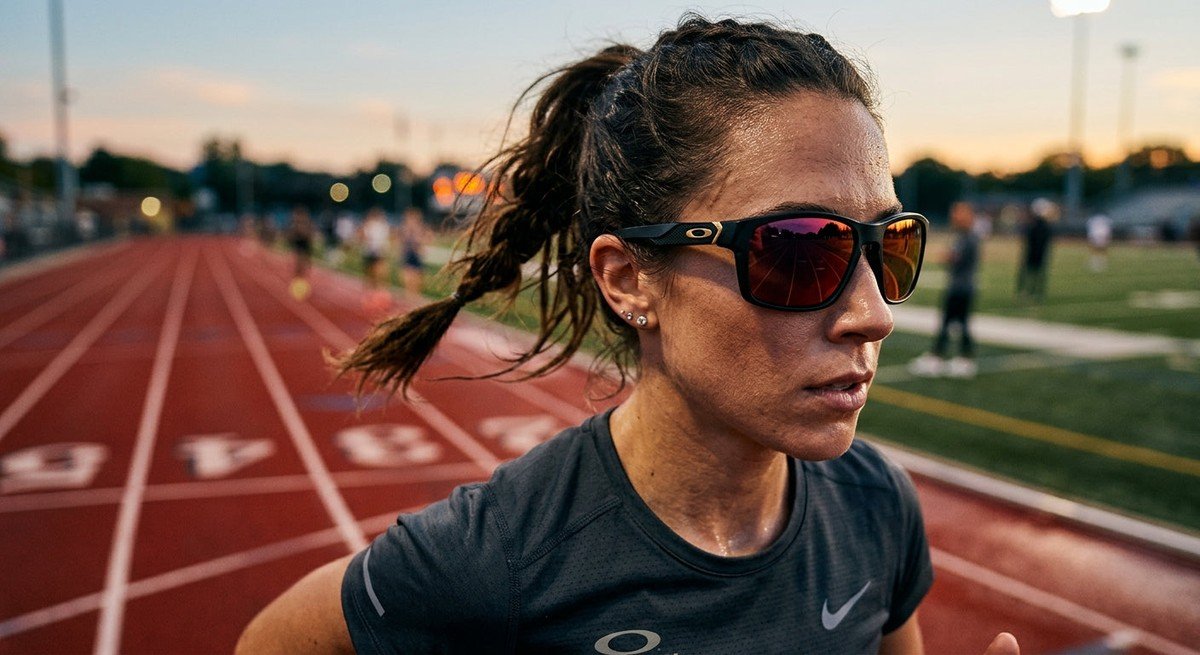 A close-up shot of the Oakley Meta Vanguard sunglasses featuring sharp, high-contrast textures against a blurred athletic track background.