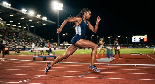 A professional runner captured in a mid-air sprint during a stadium track workout, with dramatic cinematic lighting highlighting muscle definition and motion blur.
