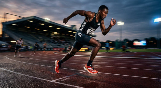 High-speed action shot of a professional athlete wearing the Adidas Adizero Adios Pro 5 on a track with motion blur