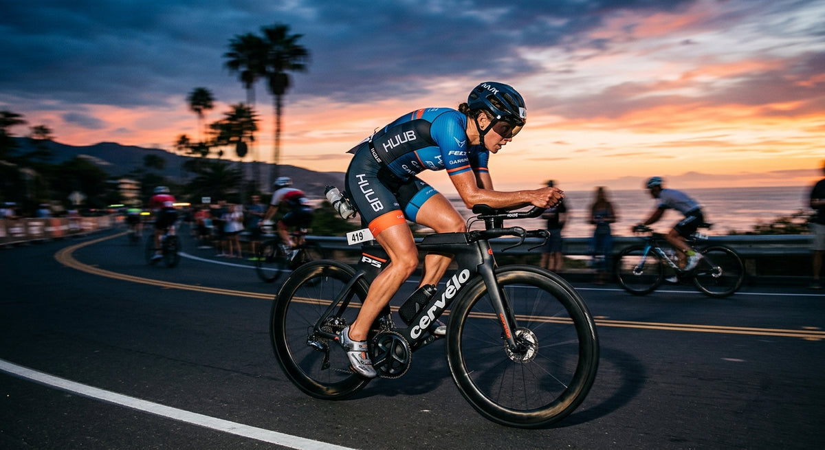 Professional triathlete in a blurred, high-speed cycling motion during a dramatic sunset race event.