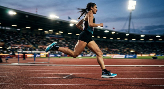 A sleek, professional side-profile shot of a high-performance Skechers running shoe mid-stride on a track, with cinematic stadium lighting and motion blur.
