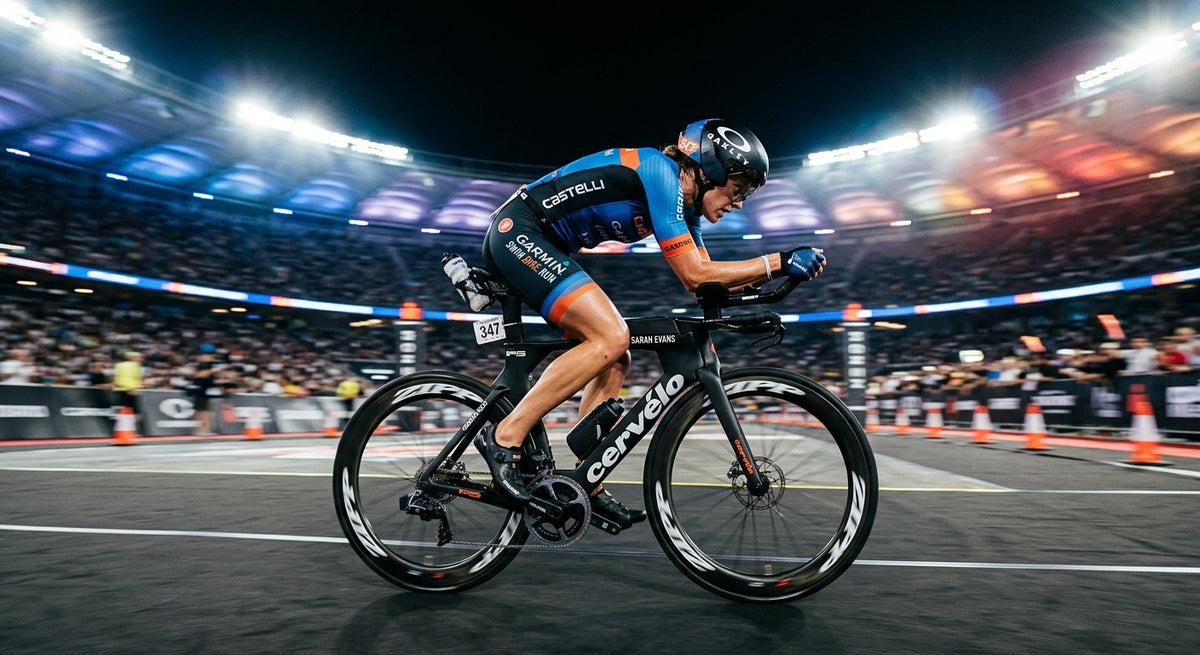 A professional triathlete in an aerodynamic position on a carbon road bike, captured with dramatic stadium lighting and high-speed motion blur.