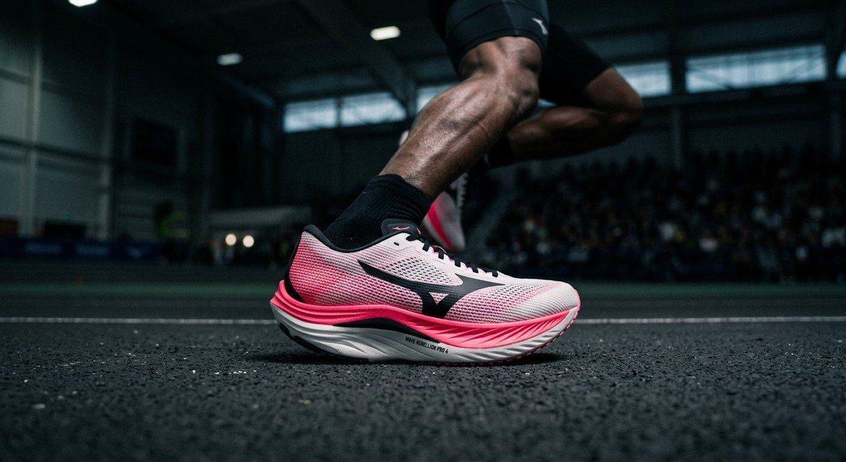 Side profile of the Mizuno Wave Rebellion Pro 4 showing the aggressive rocker geometry in cinematic lighting.