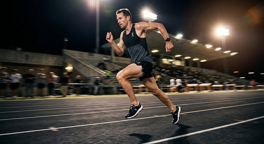 A professional action shot of a runner wearing the sleek On Cloudsurfer 3, captured in a high-contrast stadium environment with motion blur.