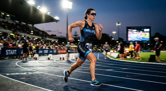 A professional high-speed action shot of a triathlete running in intense stadium lighting, wearing sleek performance sunglasses with motion blur.