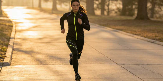 A female athlete running with perfect form to demonstrate how hip stability protects the knee joint.
