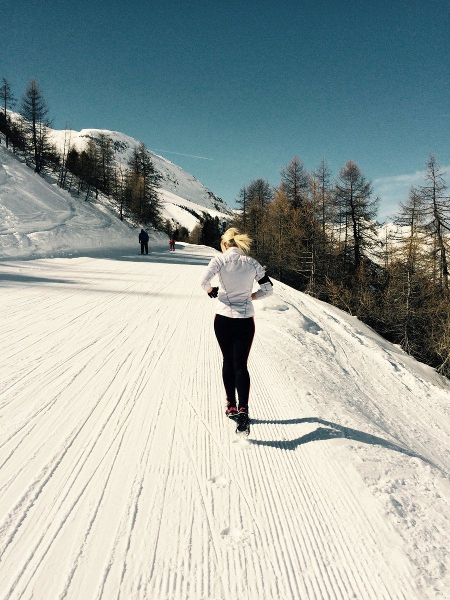 Woman Running Uphill Ski Slope Winter Snowing