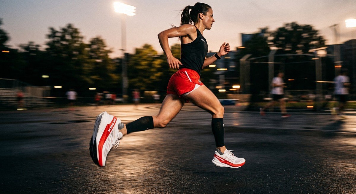 A cinematic, motion-blurred shot of the Salomon S Lab Phantasm 3 in mid-stride, showcasing the aggressive rocker geometry and crisp design details.