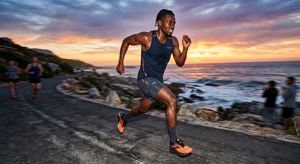 A fitness enthusiast in mid-stride during a high-intensity run, captured with motion blur and sharp athletic detail.