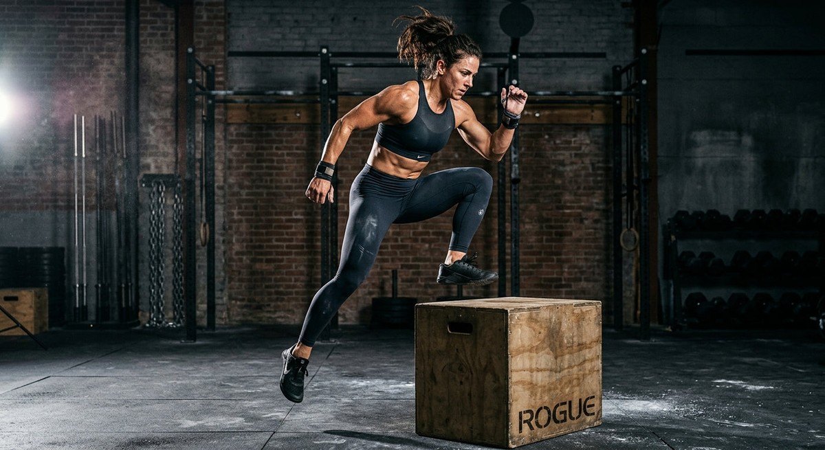 A high-speed action shot of a fitness enthusiast performing an explosive movement, showing sharp muscle definition and texture.