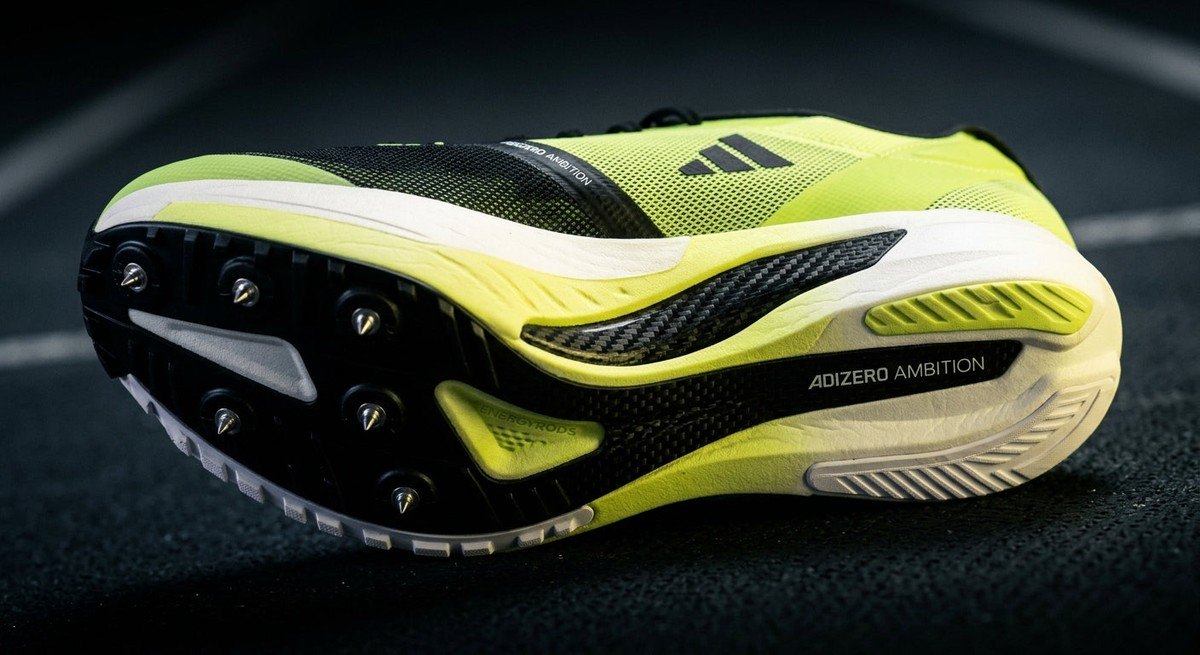 A macro studio shot showcasing the technical engineering of the Adidas Adizero Ambition midsole and carbon plate, emphasising the sleek colourway and premium construction.