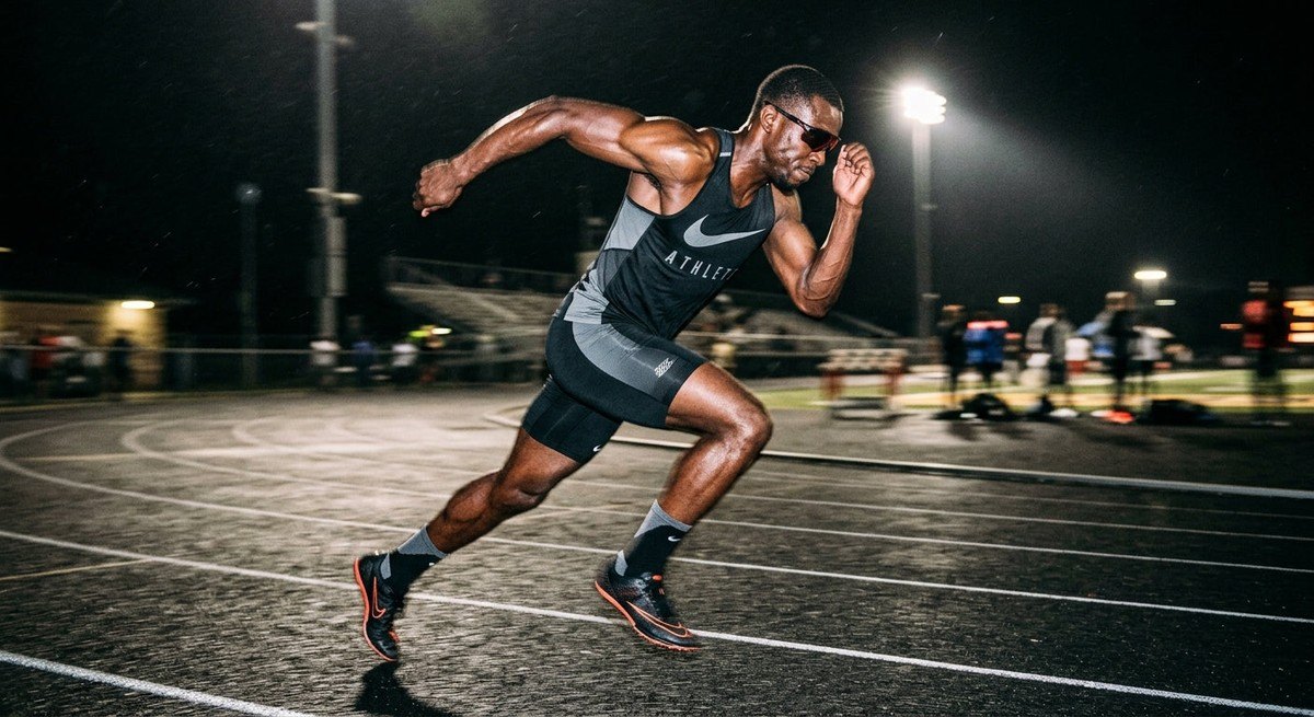 A professional athlete wearing Oakley Neoforma sunglasses during an intense sprint, captured with motion blur and high-contrast cinematic lighting.