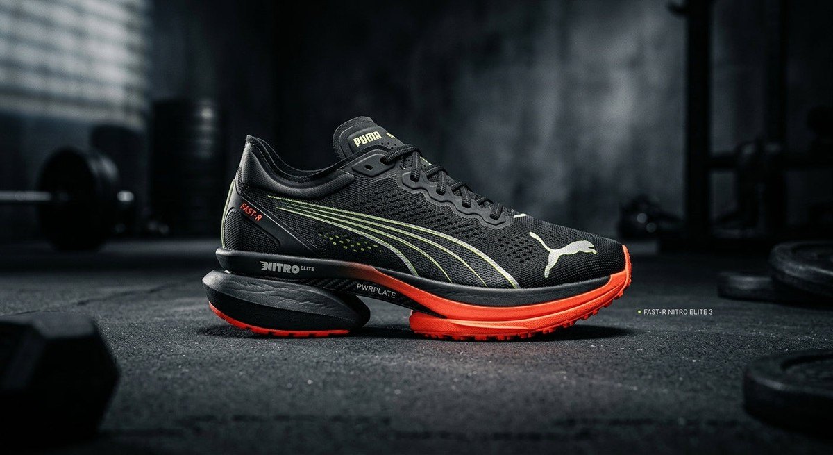 A professional, moody studio shot of the Puma Fast-R Nitro Elite 3, highlighting the decoupled midsole and mono-mesh upper with sharp, cinematic lighting and high contrast.