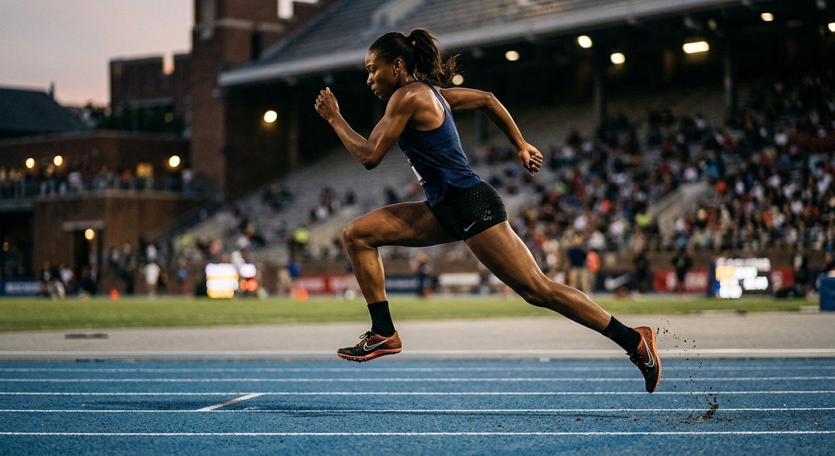A side-profile shot of an athlete in lightweight performance gear performing explosive bounding drills on a track with sharp, realistic textures and cinematic stadium contrast.