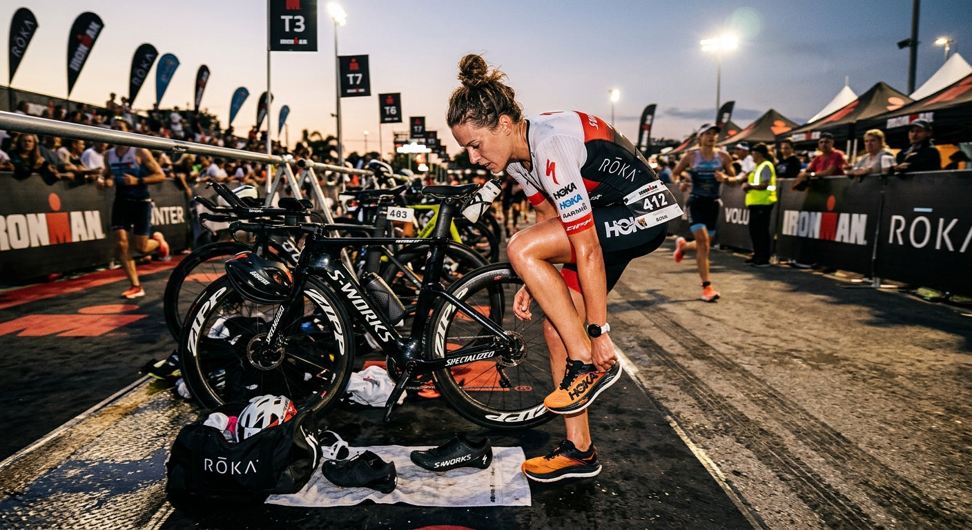A triathlete rapidly changing from cycling shoes to running shoes in a high-speed, cinematic transition zone environment.