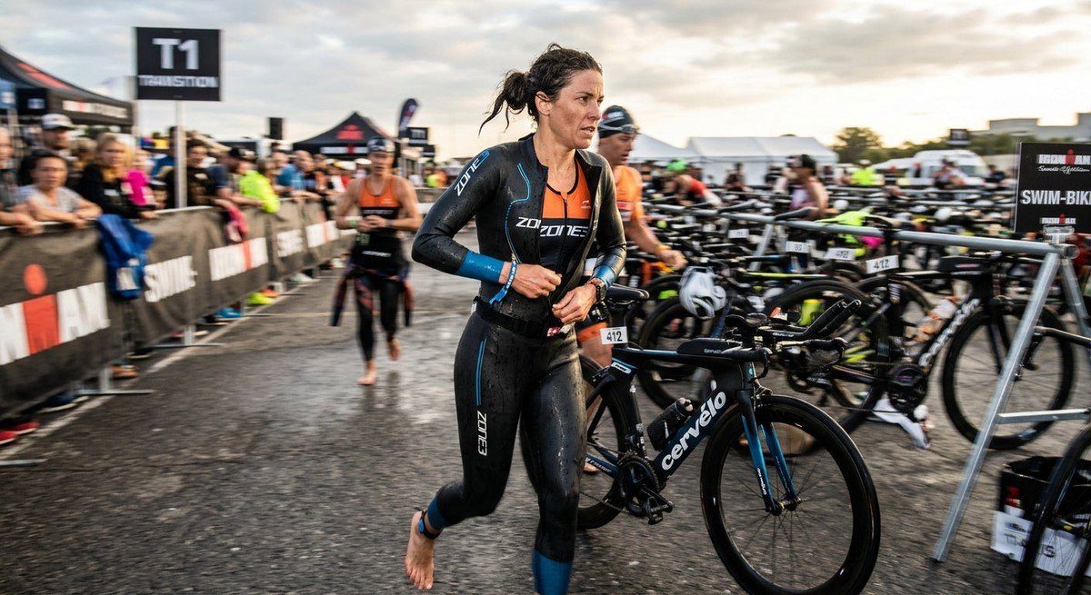 A triathlete rapidly unzipping a high-end wetsuit during a T1 transition, motion blur on the background, high-speed photography style.