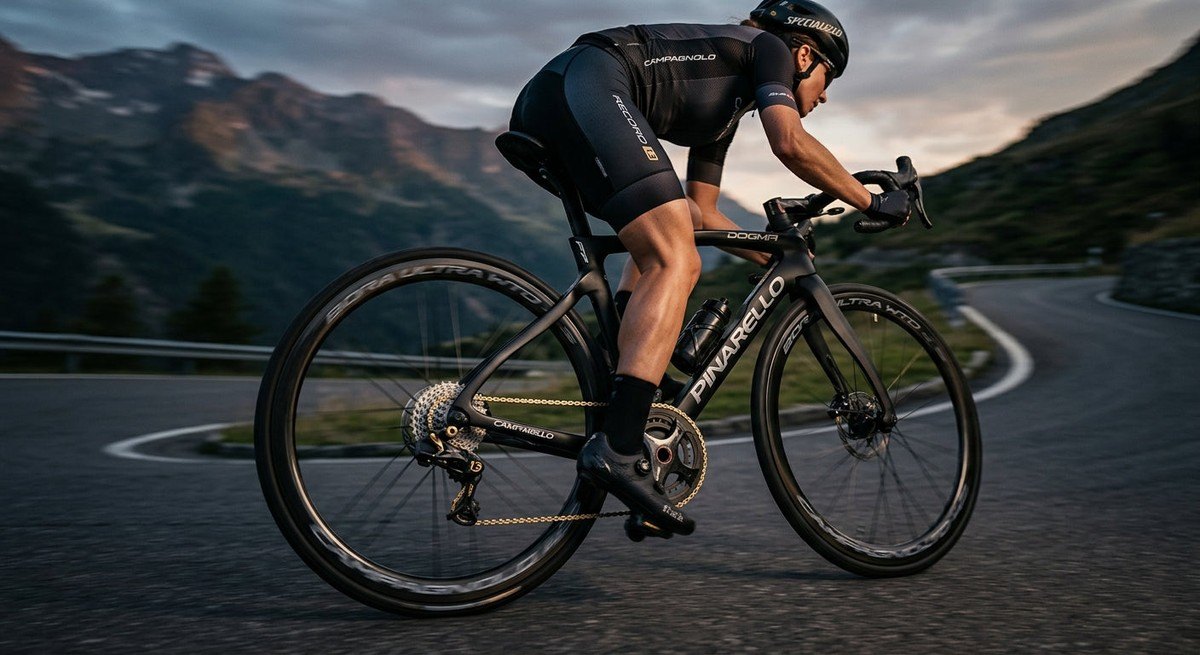 Cinematic shot of a high-end road bike drivetrain featuring the Campagnolo Record 13 wireless rear derailleur in motion.