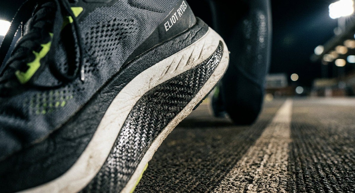 Close-up detail of the Eliot Ryder midsole and carbon plate texture with dramatic stadium lighting.