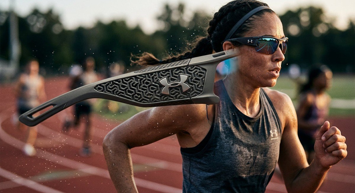 Close-up high-speed photograph of the Under Armour Grid Pro Mirror frame showing intricate texture and aerodynamic design.