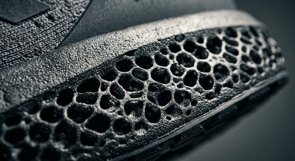 Close-up macro photography of the Hyperboost Euphoria LT midsole texture, highlighting the nitrogen-infused foam lattice with sharp, dramatic contrast lighting.