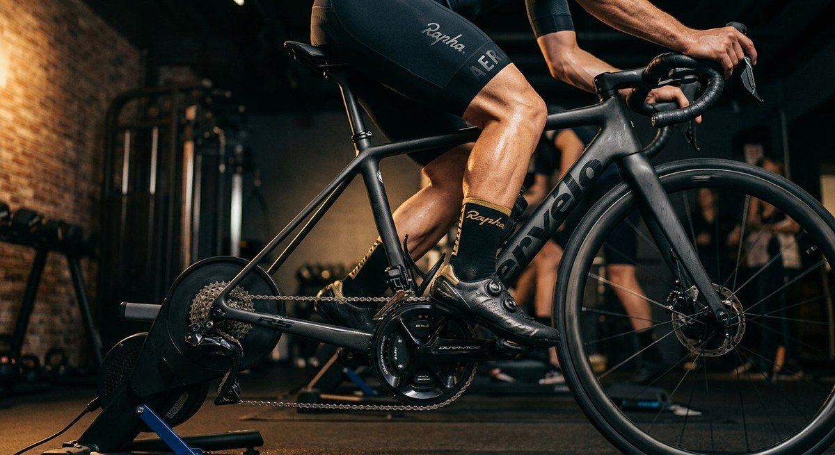 Close-up of a high-end dual-sided power meter spider integrated into a sleek carbon crankset on a professional race bike