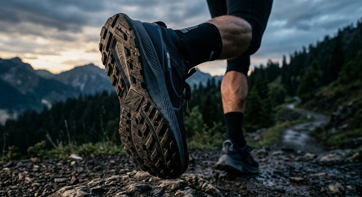 Close-up of a high-performance running shoe sole, highlighting the advanced geometric tread pattern and material texture in a moody, cinematic setting.
