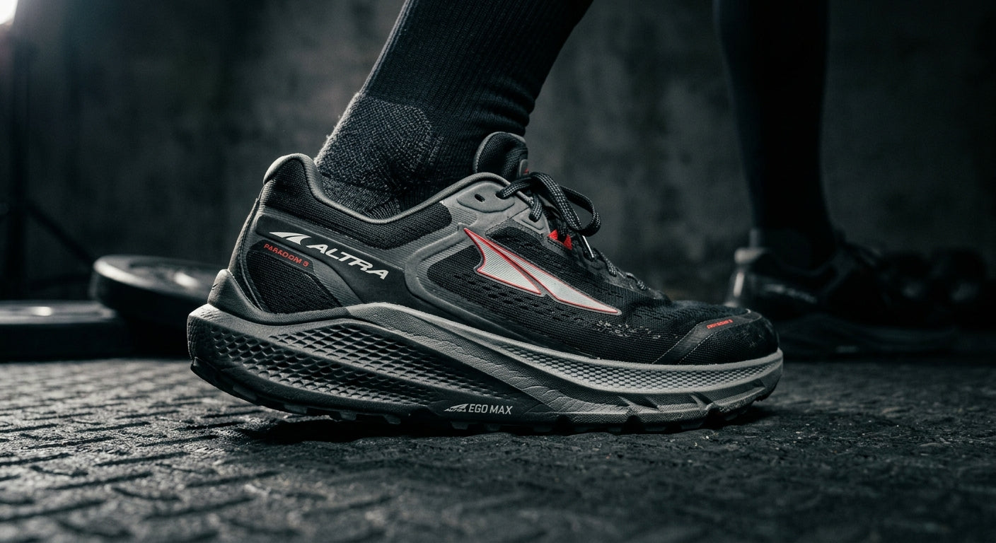 Close-up of the Altra Paradigm 9 midsole geometry showing technical textures and high-performance material construction in a moody studio setting.