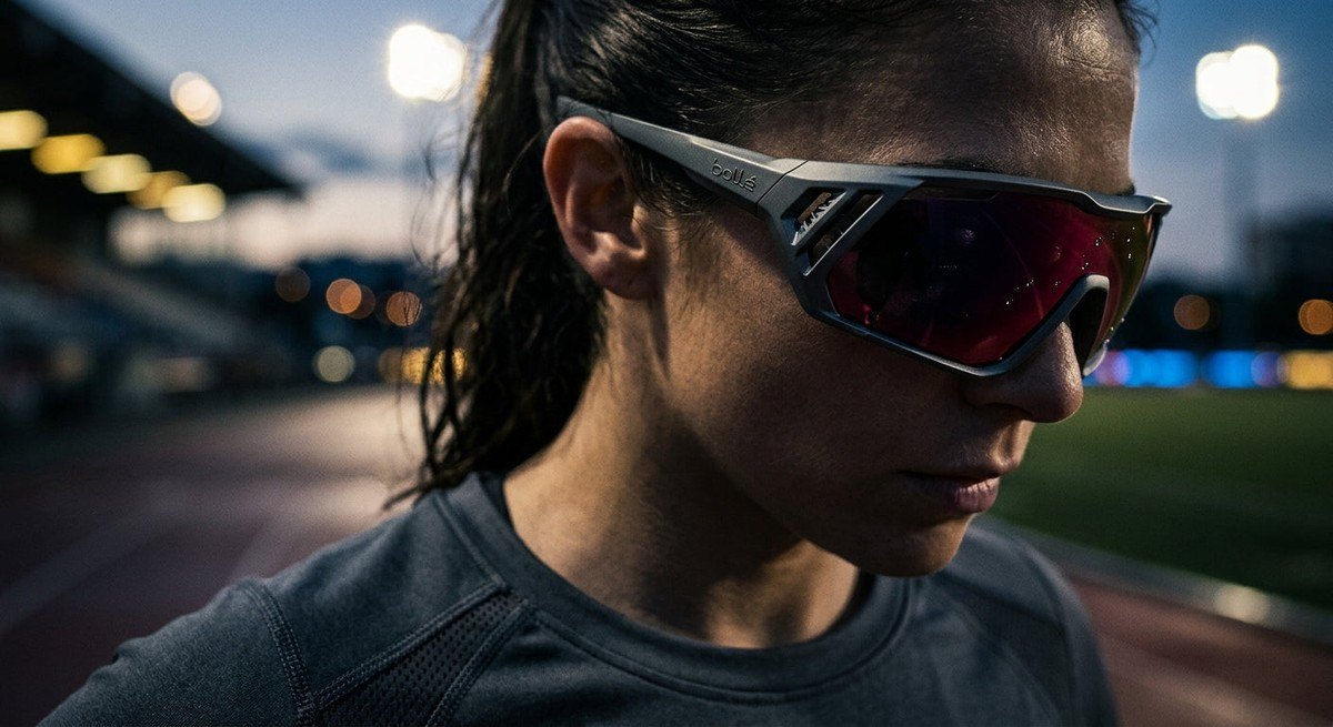 Close-up of the Bollé Victus Pro frame geometry showing the intricate ventilation channels and high-quality lens finish in moody lighting.