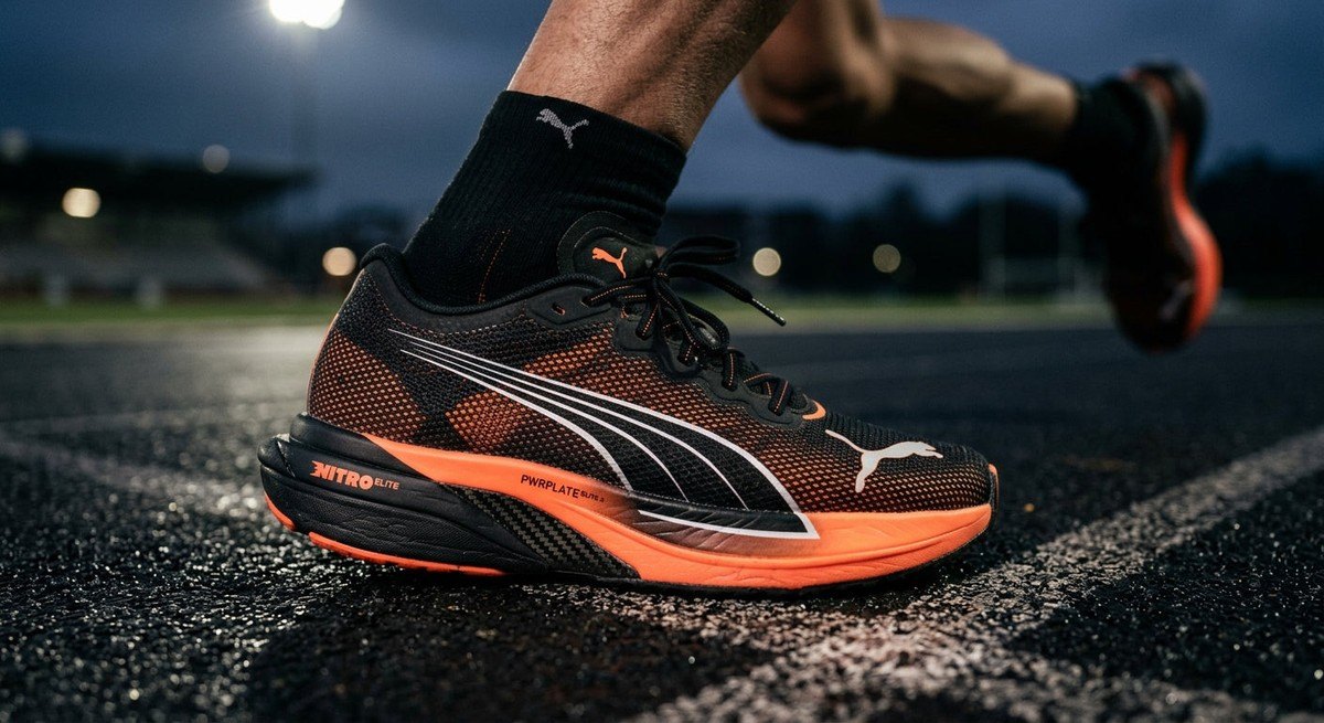 Close-up of the carbon-plated midsole and advanced mesh upper of the Puma Deviate Nitro Elite 4 with dramatic lighting.