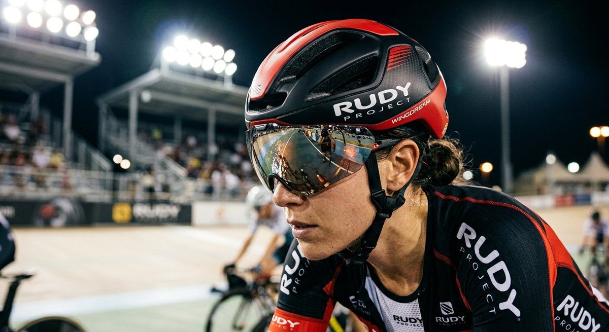 Close-up of the Rudy Project Wingdream magnetic visor reflecting stadium lights, capturing the sleek, high-end Italian design texture.