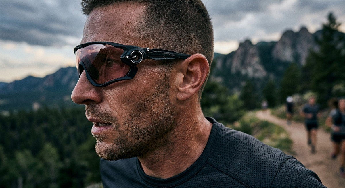 Close-up profile of a high-tech sports eyewear frame showing textured O-Matter material and precise lens curvature.