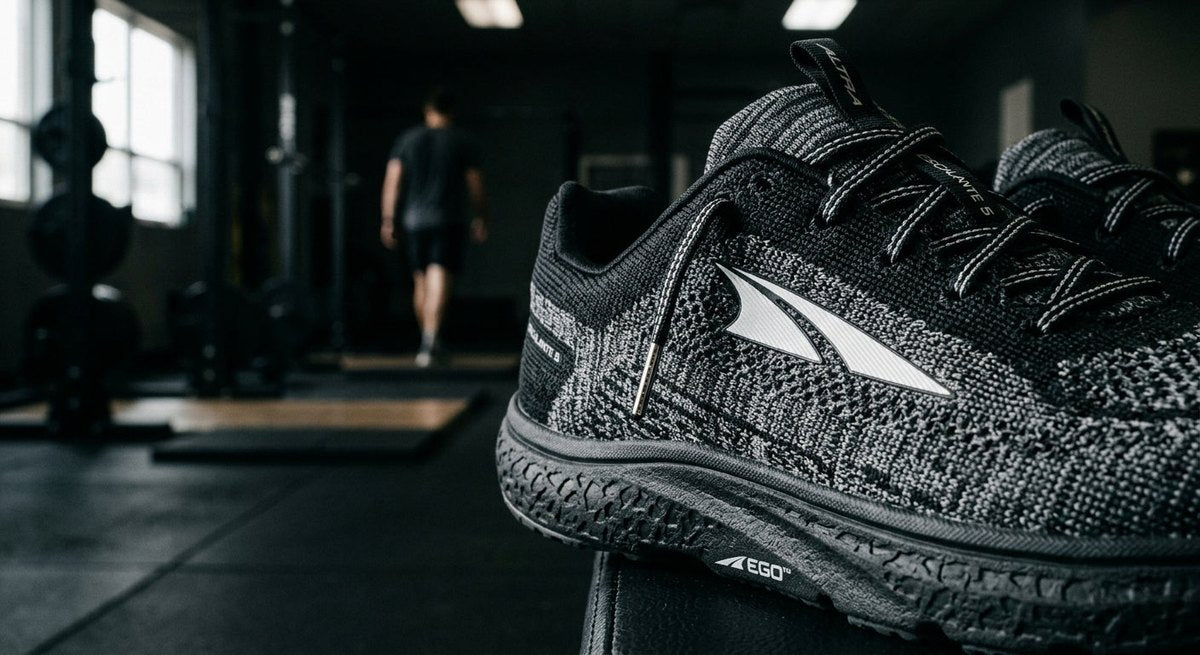 Detailed close-up shot of the Altra Escalante 5 knit upper texture and midsole foam, captured with sharp focus and cinematic moody lighting.