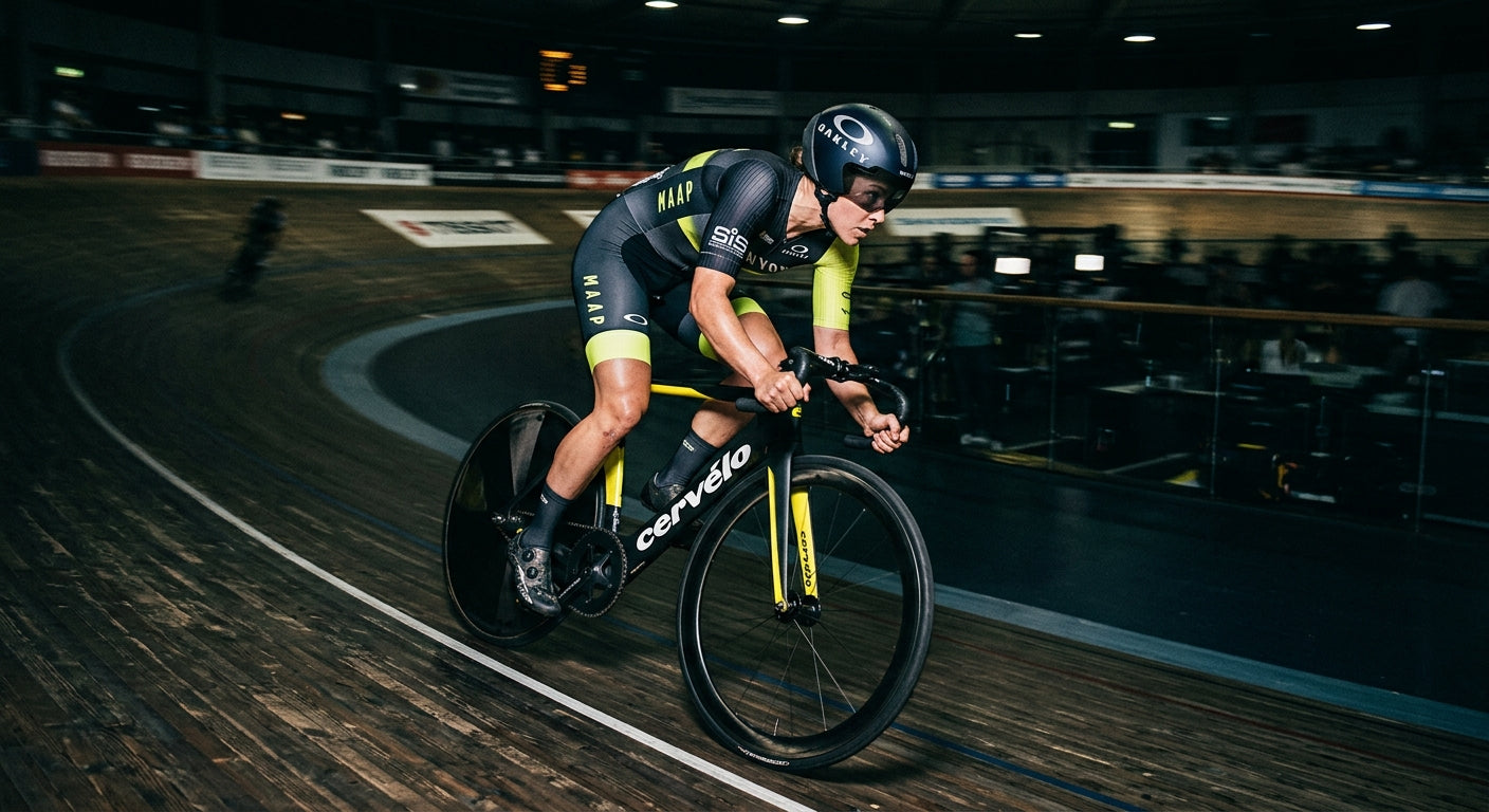 Dramatic high-speed action shot of a cyclist in a velodrome with sharp focus and moody, high-contrast lighting.