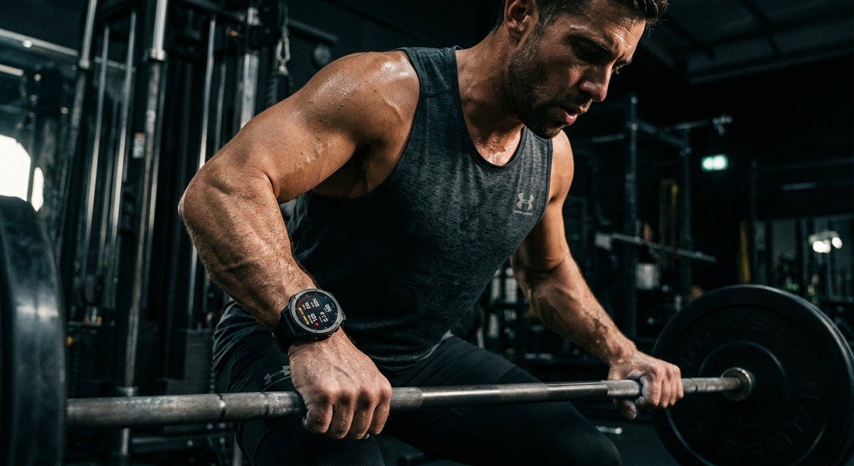 Dramatic, moody studio shot of a rugged titanium smartwatch face glowing with a sharp, high-contrast digital interface.