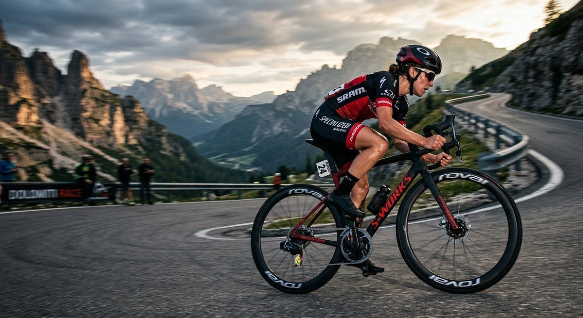 Dynamic action photography of a cyclist racing on a mountain pass with motion blur, highlighting the precision of an electronic gear shifting system.
