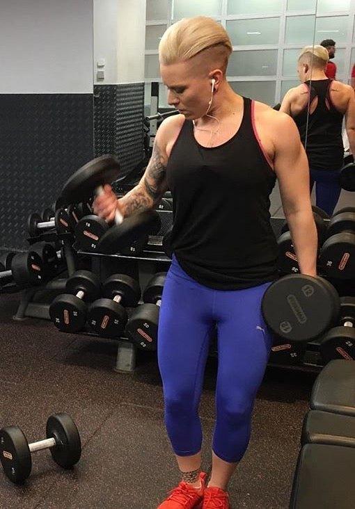 personal trainer lifting weights at the gym