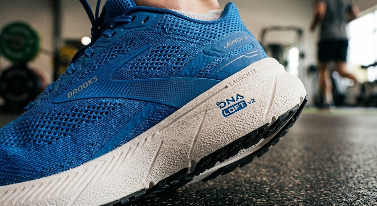 Macro close-up of the technical mesh upper and midsole material of the Brooks Launch 12 showing realistic textures and high-performance craftsmanship.