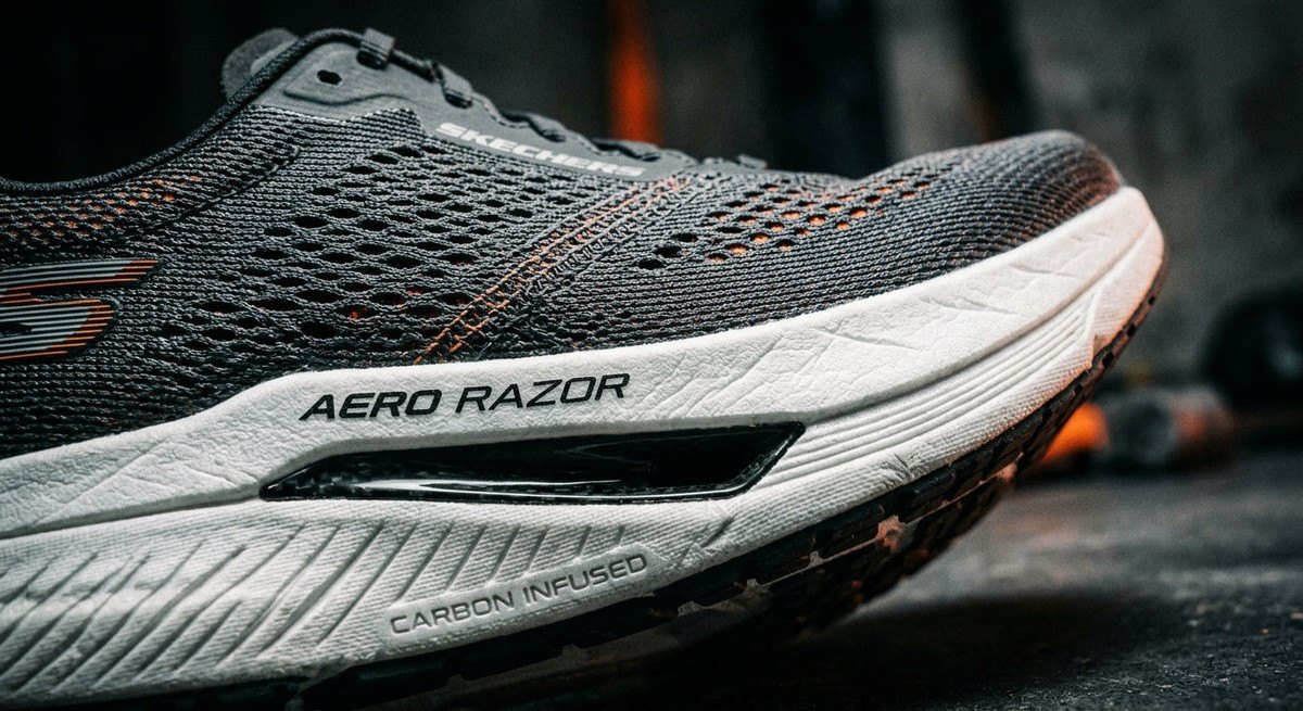 Macro shot of the Skechers Aero Razor carbon-plated midsole and engineered mesh texture under moody, contrast-heavy lighting.